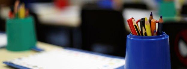 Crayons on a classroom desk