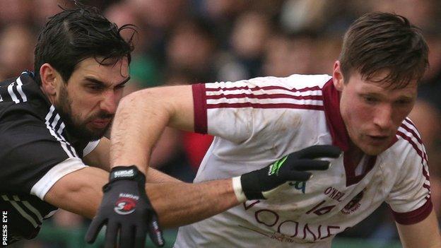 Niall Branagan of Kilcoo in action with Slaughtneil's Se McGuigan