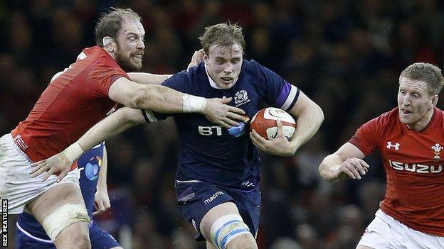 Jonny Gray goes between Alun Wyn Jones (left) and Bradley Davies of Wales