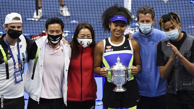 Naomi Osaka celebrates her second US Open win with her team and boyfriend Cordae (on the far right)