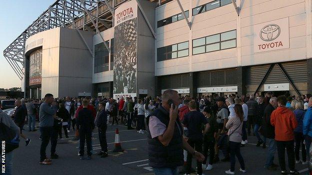 Fans outside Pride Park during an evacuation