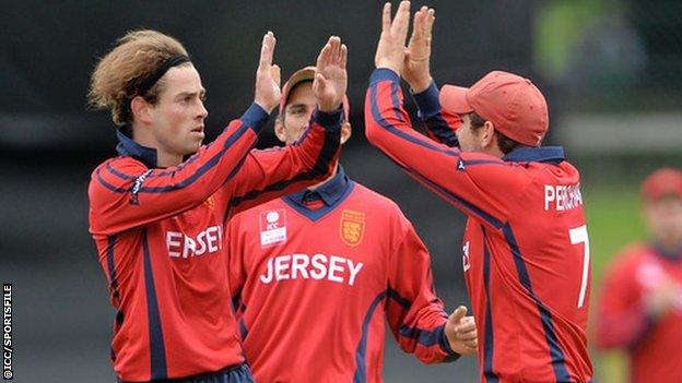 Jersey bowler Corne Bodenstein celebrates taking a wicket