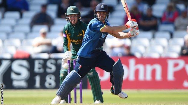 Kent batsman Heino Kuhn plays a shot while Nottinghamshire wicketkeeper Tom Moores looks on