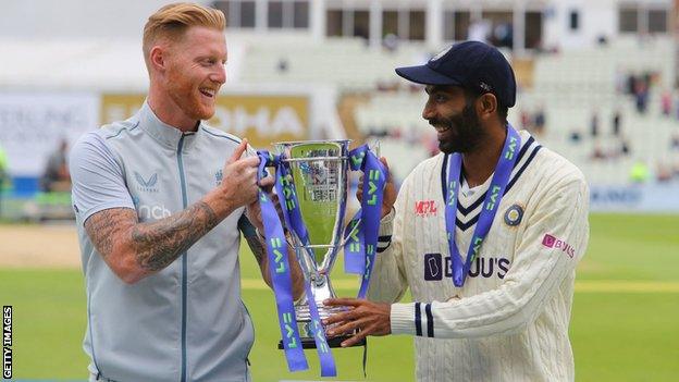 Ben Stokes (left) and Jasprit Bumrah (right) hold up the trophy after the England-India Test series is drawn 2-2