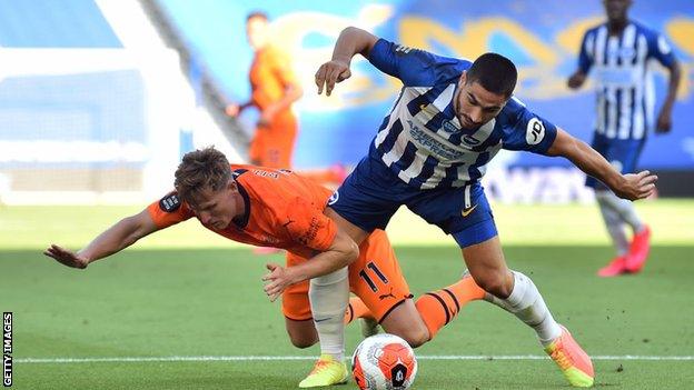 Matt Ritchie tangles with Neal Maupay inside the Newcastle area