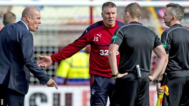 Rangers' Mark Warburton (left) confronts the officials at Pittodrie