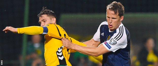 Lithuania's Fiodor Cernych is grappled by Scotland's Christophe Berra