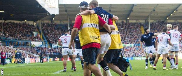 Finn Russell leaves the field injured for Scotland against the USA