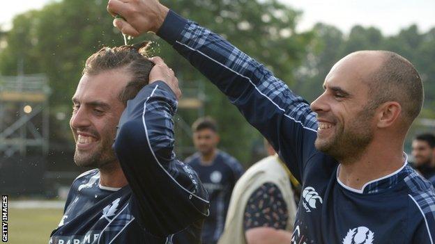 Scotland's Calum MacLeod (left) celebrates with captain Kyle Coetzer