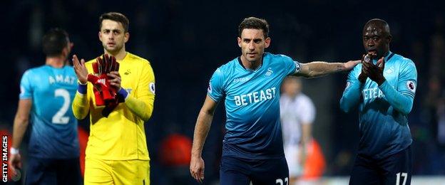 Swansea City players following the defeat by West Brom