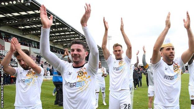 Newport County players applaud their fans