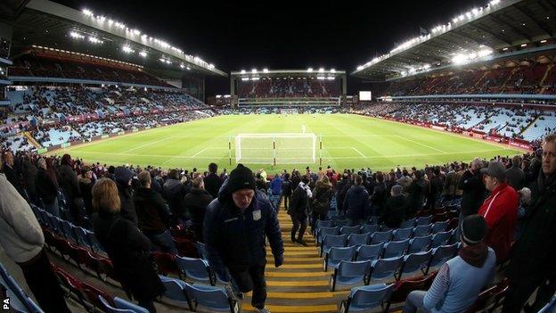 Aston Villa fans head for the exits during the match against Everton