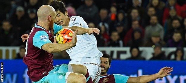 James Collins throws his body at the ball to block Ki Sung-yueng's goal-bound effort