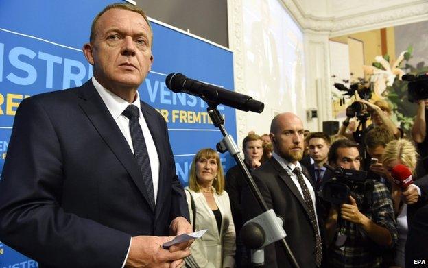 Leader of the centre-right liberal party Venstre, Lars Loekke Rasmussen (left) looks on as he speaks to members of the media after the Danish elections, in Copenhagen, Denmark, 18 June 2015