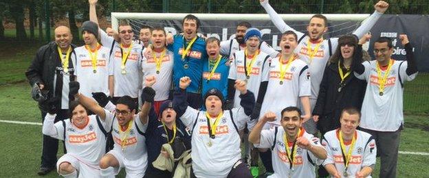 Disability football teams posing for photo