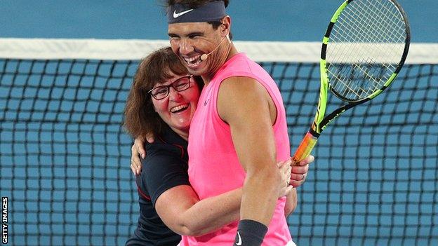 Rafael Nadal with a female firefighter