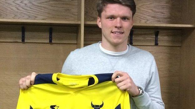 Rob Dickie holds up an Oxford United shirt