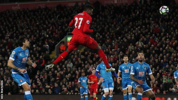 Divock Origi climbs above the Bournemouth defence to score for Liverpool