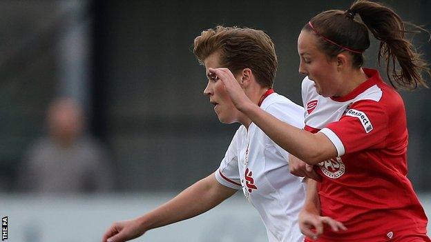 Katrin Omarsdottir of Liverpool holds off the challenge of Caroline Weir (right)