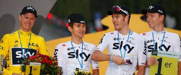 Luke Rowe (second from right) celebrates with 2017 Tour de France winner Chris Froome (l) and team-mates Michal Kwiatkowski and Christian Knees