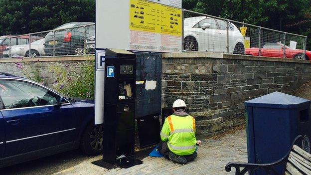 Parking meter being fixed