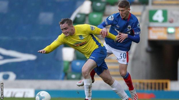 Ballymena defender Andrew Burns is challenged by Linfield's Charlie Allen