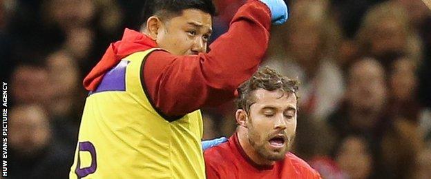 Leigh Halfpenny looks groggy as he receives treatment after taking a blow to the head playing for Wales against Australia in November 2018