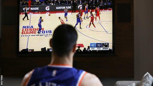 Knicks centre Enes Kanter watches the game on TV in New York