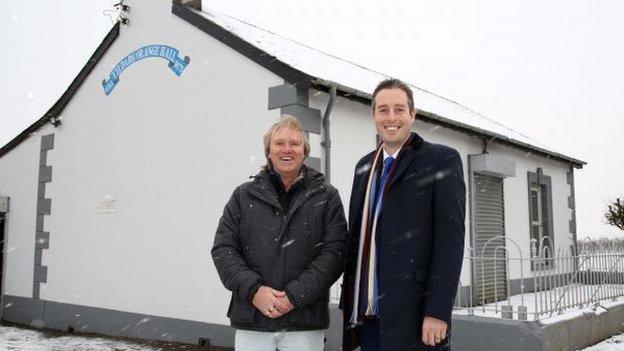 Mr Givan was photographed outside Tildarg Orange Hall as he made the funding announcement