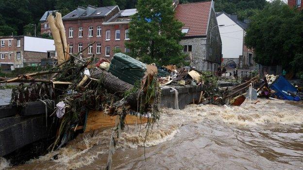 Flooding in Belgium has washed branches and other items along the roads