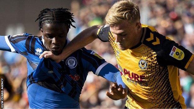 Will Evans of Newport County in action against Femi Seriki of Rochdale