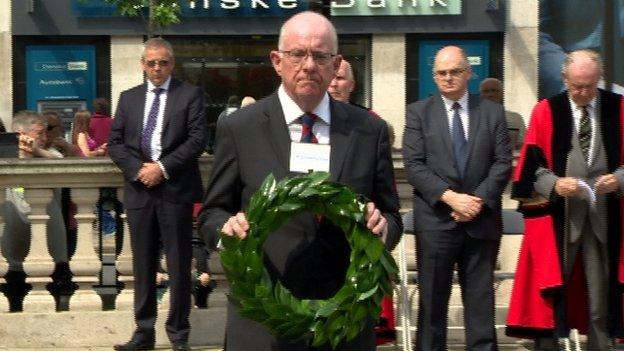 Republic of Ireland Minister, Charlie Flanagan laying a wreath at Belfast City Hall