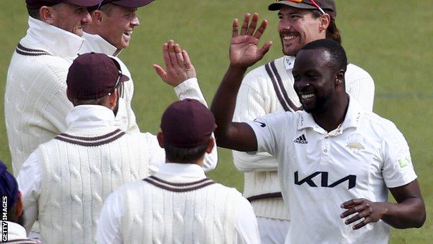 Kemar Roach celebrates a wicket for Surrey