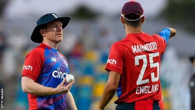 England Captain Eoin Morgan talking to pace-bowler Saqib Mahmood.