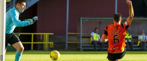 Lewis Toshney (right) scores