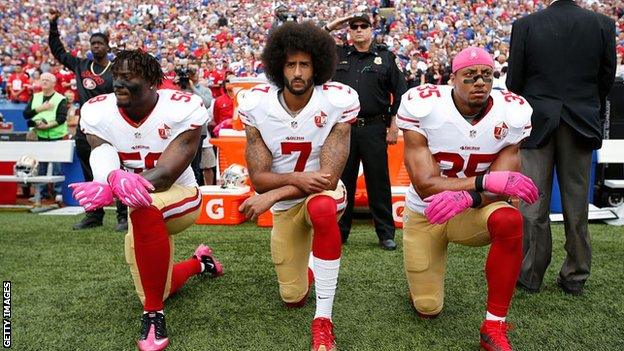 Colin Kaepernick (centre) first took the knee in September 2016