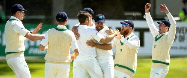 Ireland players rush in to celebrate the dismissal of Pakistan opener Azhar Ali