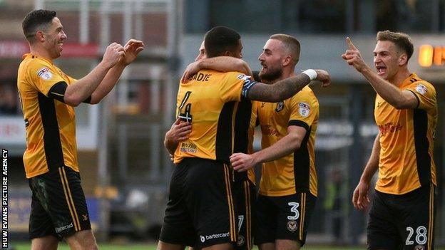 Newport County's players celebrate their win over Cambridge United in the second round of the FA Cup