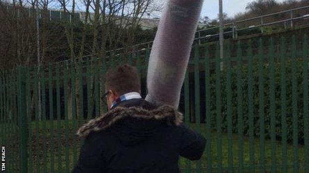 We still don't, however, know why this football fan was making his way to Wycombe's Adams Park with a roll of carpet...