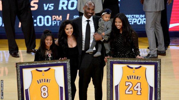 Kobe Bryant poses with his family at halftime after both his #8 and #24 Los Angeles Lakers jerseys are retired at Staples Center on December 18, 2017 in Los Angeles, California.