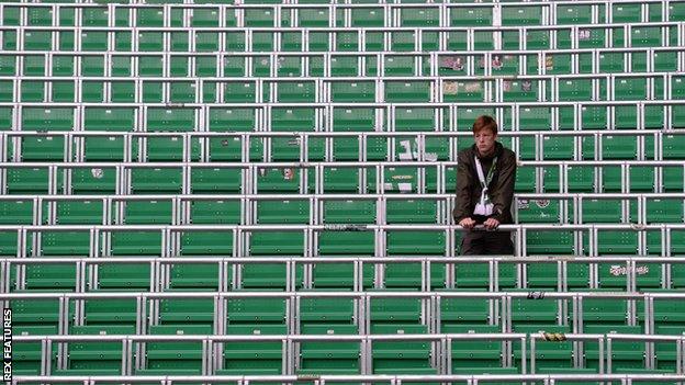 Fan standing in the safe-standing section at Celtic Park