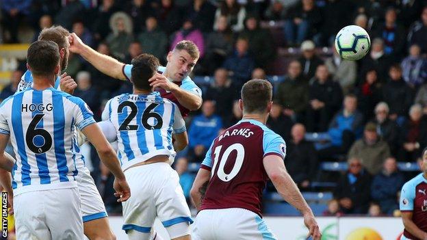 Sam Vokes of Burnley scores a header against Huddersfield