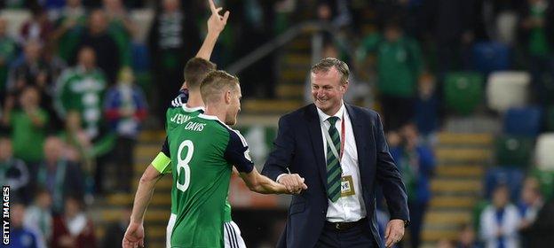 Michael O'Neill shakes hands with Northern Ireland captain Steven Davis