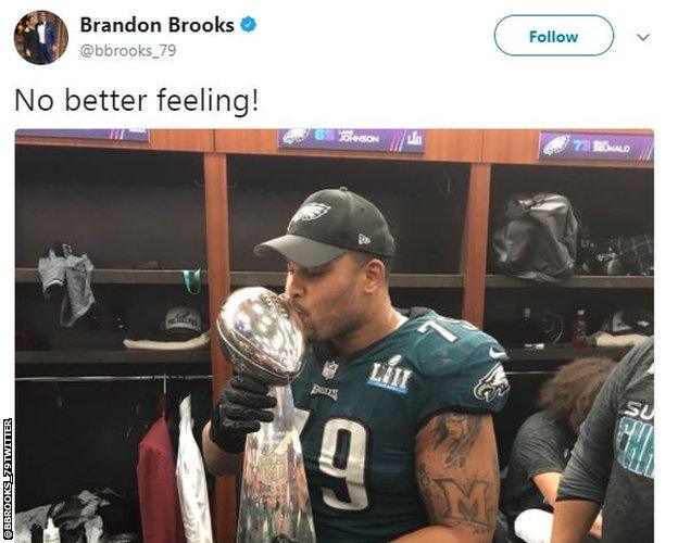 Brandon Brooks celebrates with the Vincent Lombardi trophy