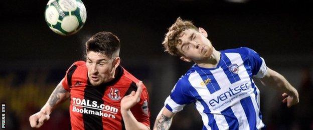 Crusaders' Michael Ruddy with Coleraine's Jamie McGonigle