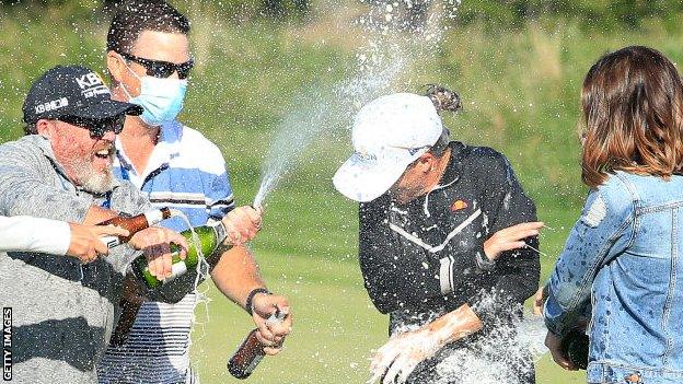 Mel Reid being doused with champagne