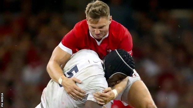 Wales fly-half Dan Biggar tackles England lock Maro Itoje