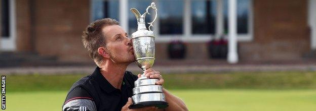 Henrik Stenson of Sweden celebrates victory as he kisses the Claret Jug on the the 18th green after the final round on day four of the 145th Open Championship at Royal Troon