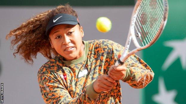 Naomi Osaka playing a shot