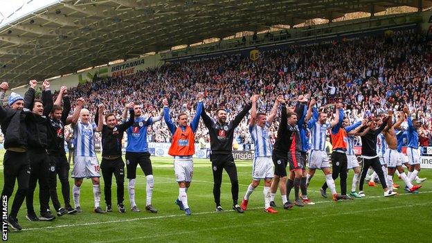 Huddersfield players salute the fans after beating Watford